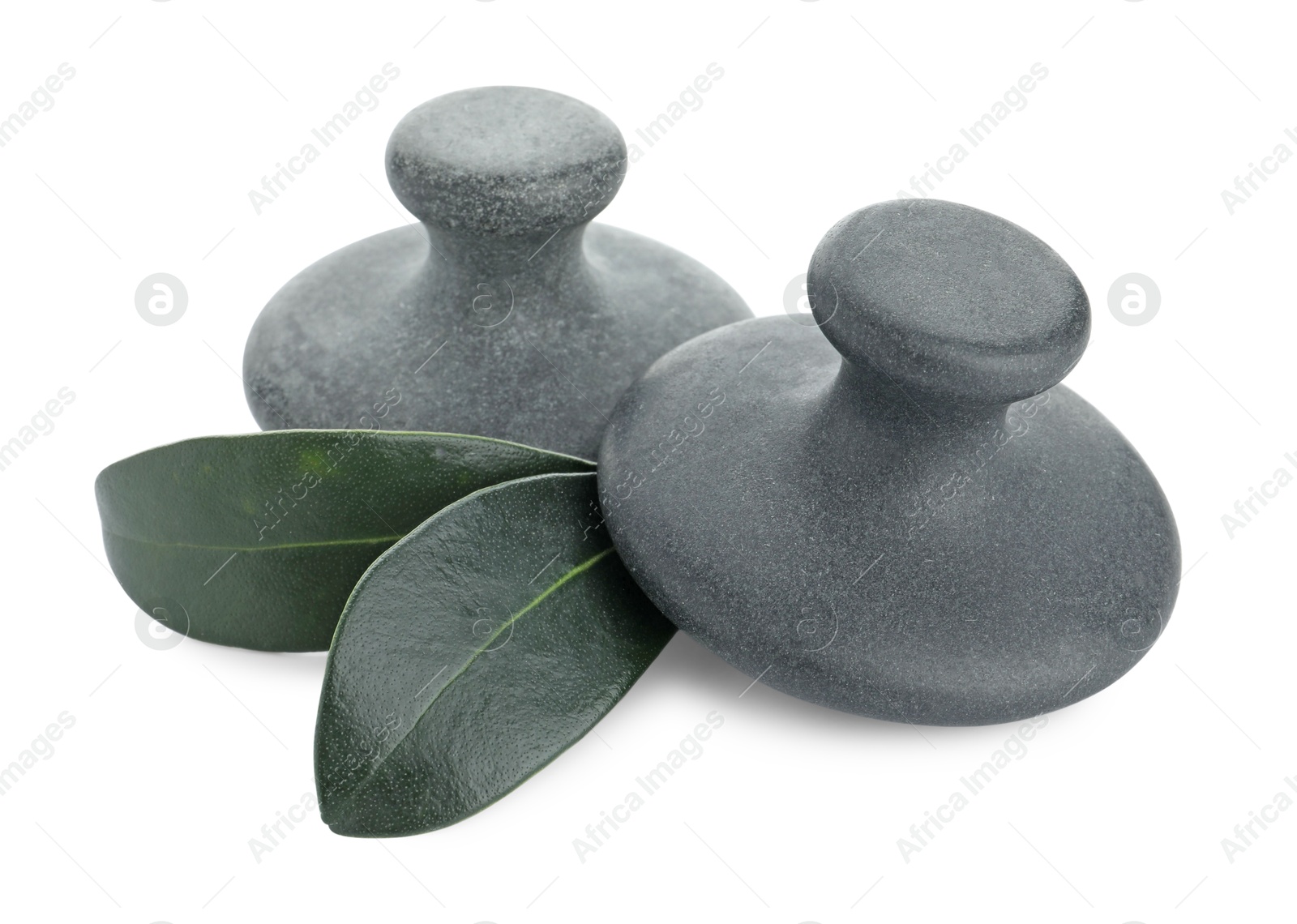 Photo of Spa stones and green leaves isolated on white