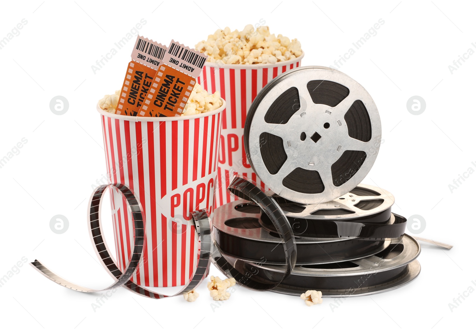 Photo of Tasty popcorn, film reels and movie tickets isolated on white