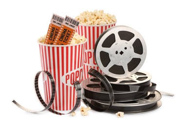 Photo of Tasty popcorn, film reels and movie tickets isolated on white