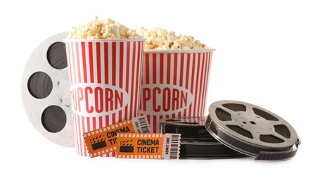 Photo of Tasty popcorn, film reels and movie tickets isolated on white