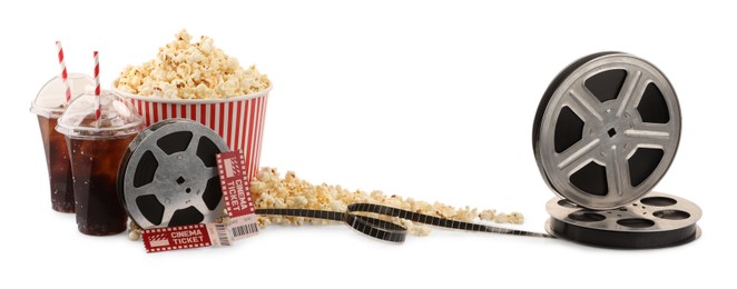 Photo of Tasty popcorn, film reels, soda drinks, glasses and movie tickets isolated on white