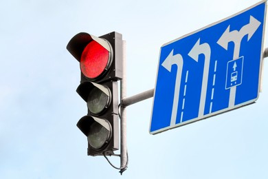 Photo of Traffic light against blue sky in city