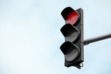 Photo of Traffic light against blue sky in city. Space for text