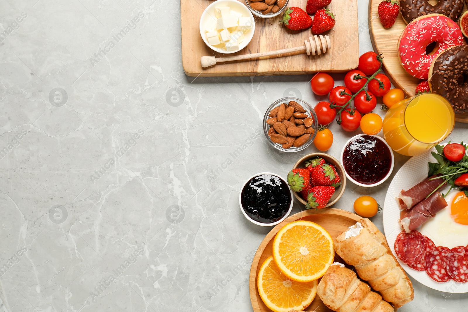 Photo of Different tasty food served for brunch on grey marble table, flat lay. Space for text