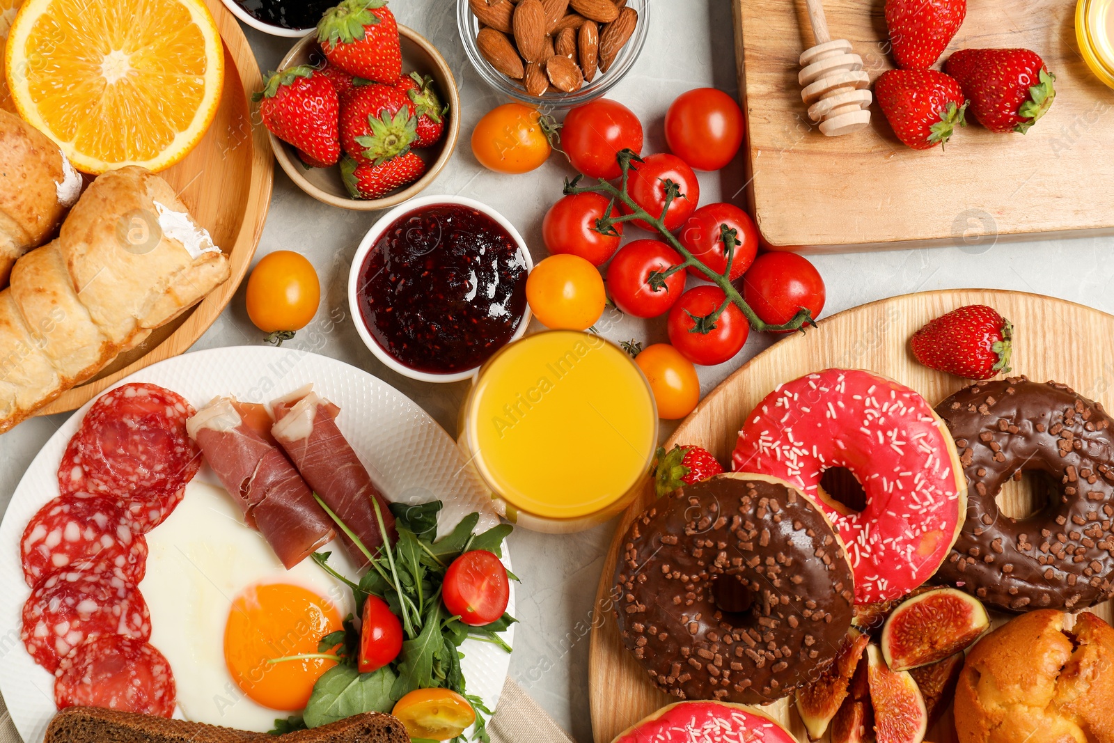 Photo of Different tasty food served for brunch on grey marble table, flat lay