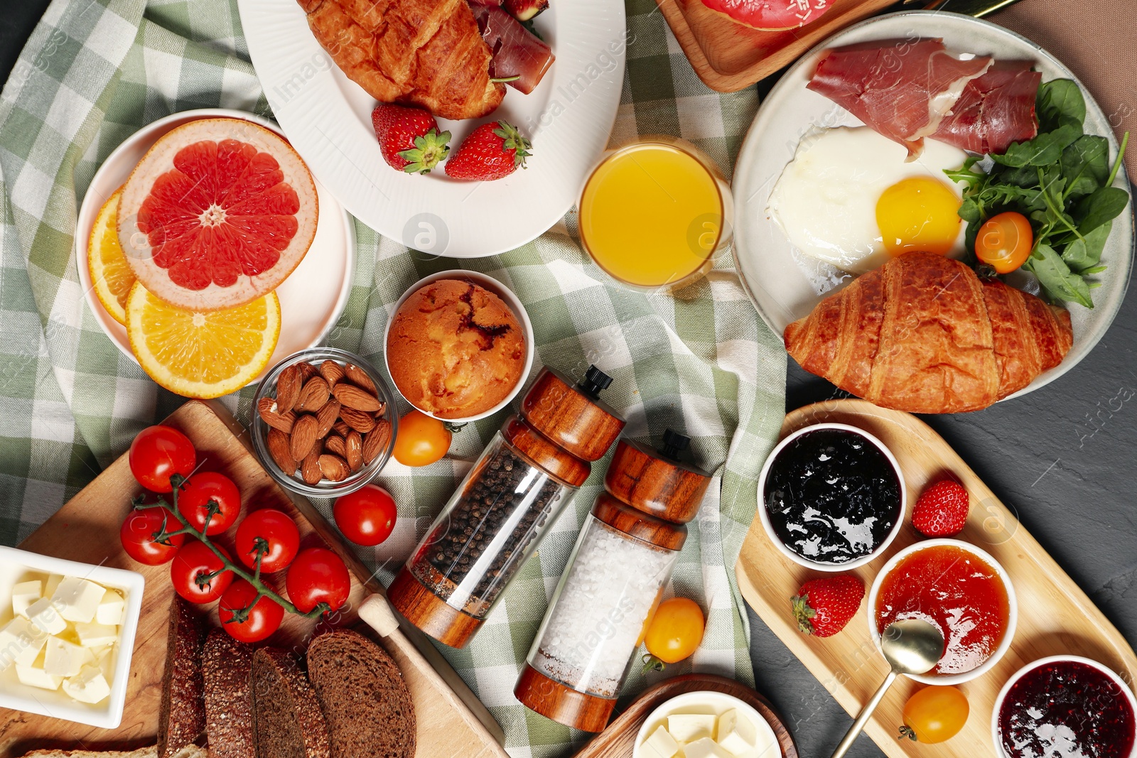 Photo of Different tasty food served for brunch on grey textured table, flat lay