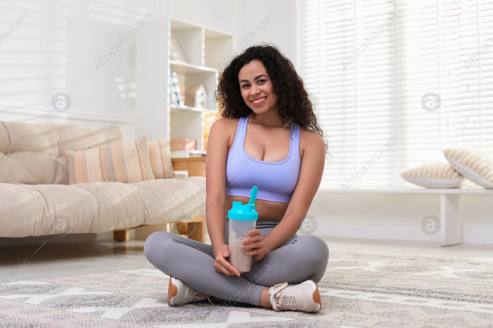 Photo of Beautiful woman with protein shake at home