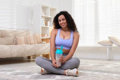 Photo of Beautiful woman with protein shake at home