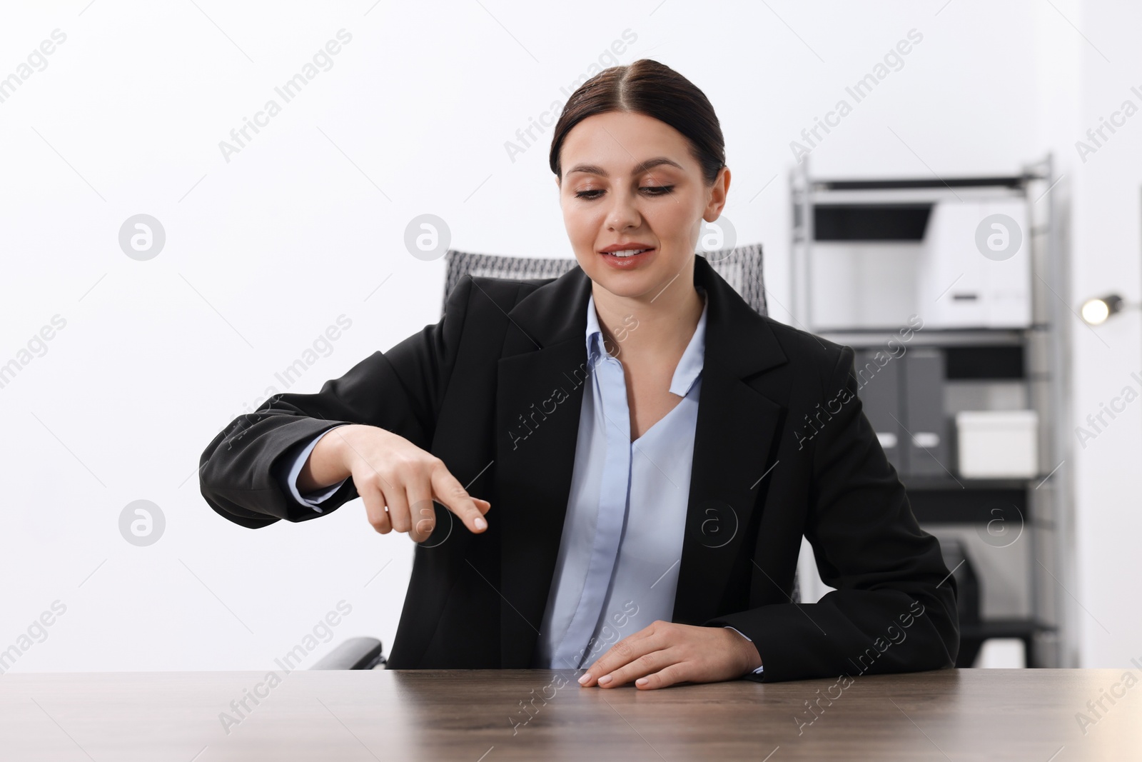 Photo of Beautiful woman pointing at something in office