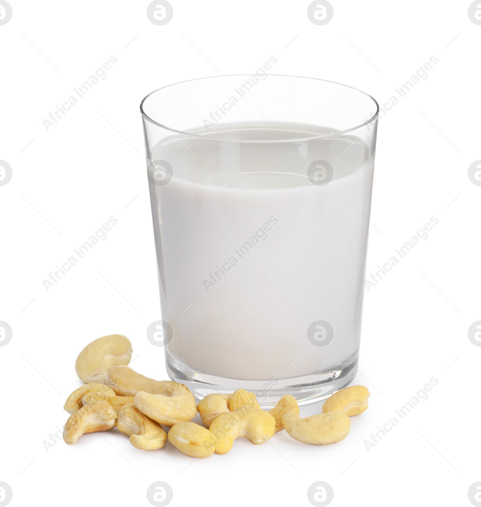 Photo of Fresh cashew milk in glass and nuts isolated on white