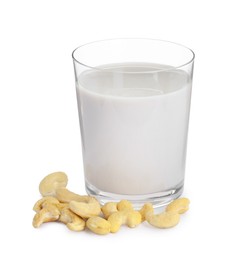 Photo of Fresh cashew milk in glass and nuts isolated on white