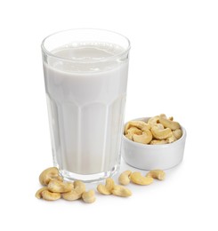 Photo of Fresh cashew milk in glass and nuts isolated on white