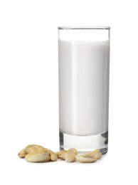 Photo of Fresh cashew milk in glass and nuts isolated on white