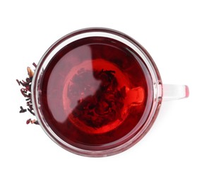 Photo of Delicious hibiscus tea in glass cup and dry roselle sepals isolated on white, top view