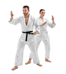 Photo of Karate fighters in uniform on white background