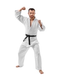 Photo of Man in uniform practicing karate on white background