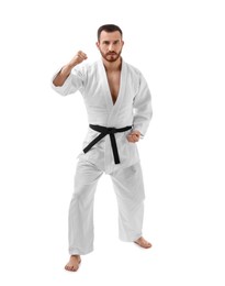 Photo of Man in uniform practicing karate on white background