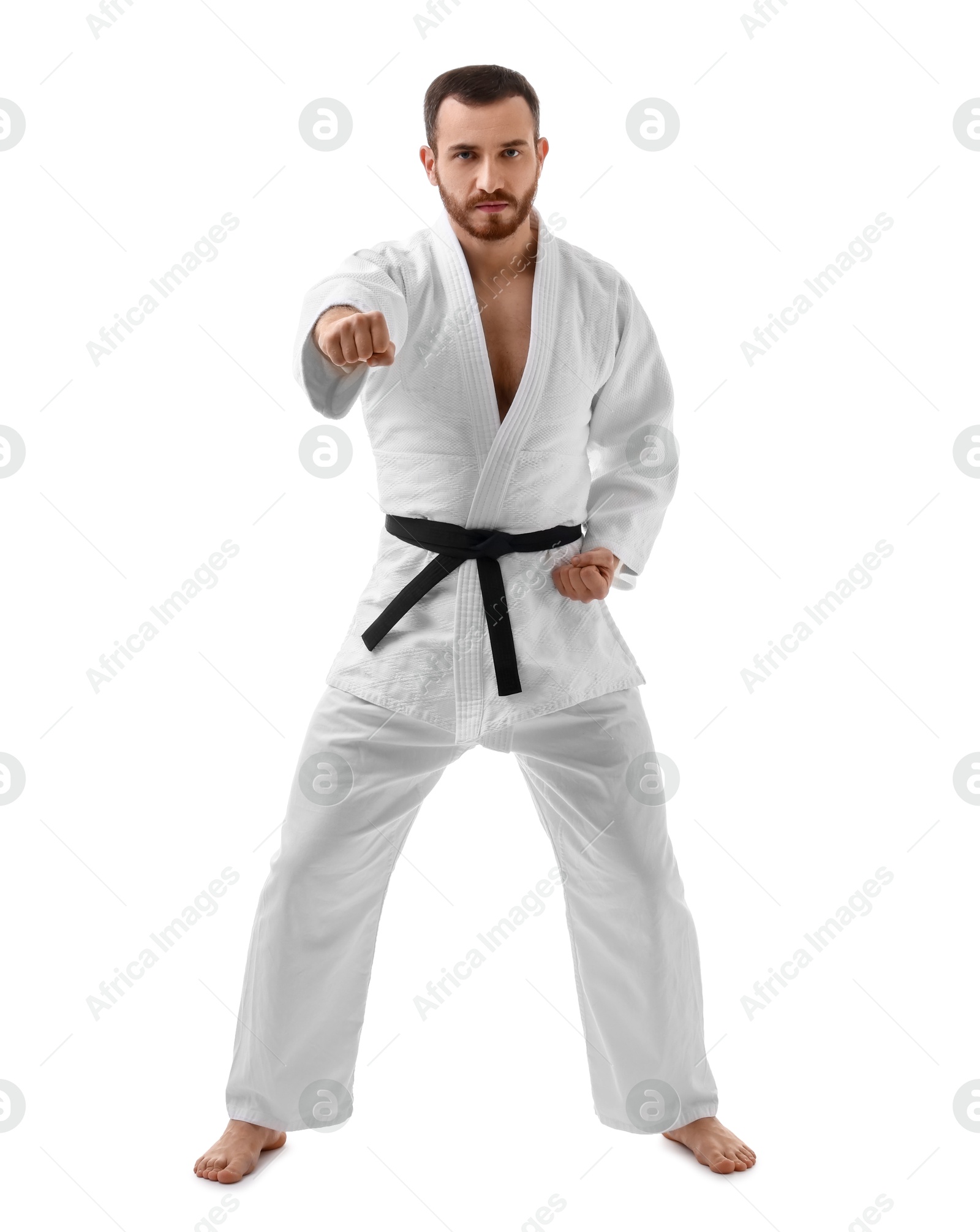 Photo of Man in uniform practicing karate on white background