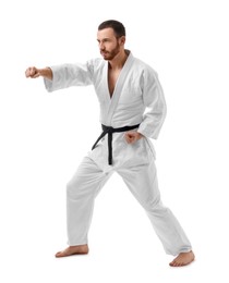 Photo of Man in uniform practicing karate on white background