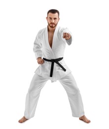 Photo of Man in uniform practicing karate on white background