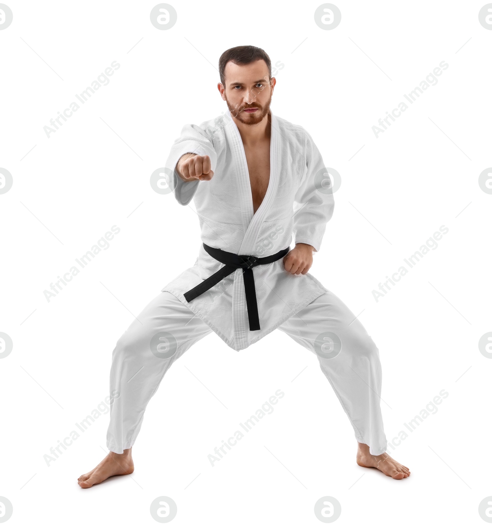 Photo of Man in uniform practicing karate on white background