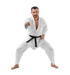 Photo of Man in uniform practicing karate on white background