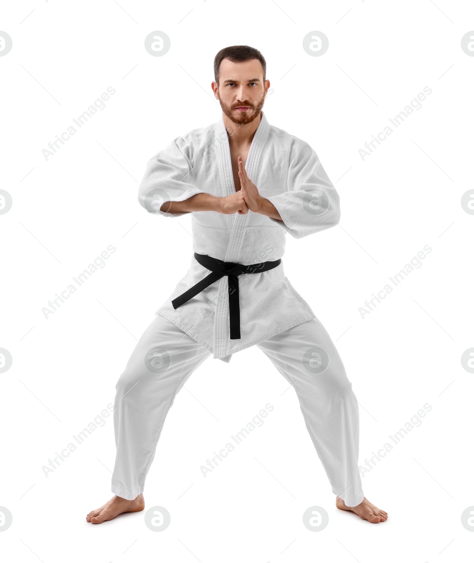 Photo of Man in uniform practicing karate on white background