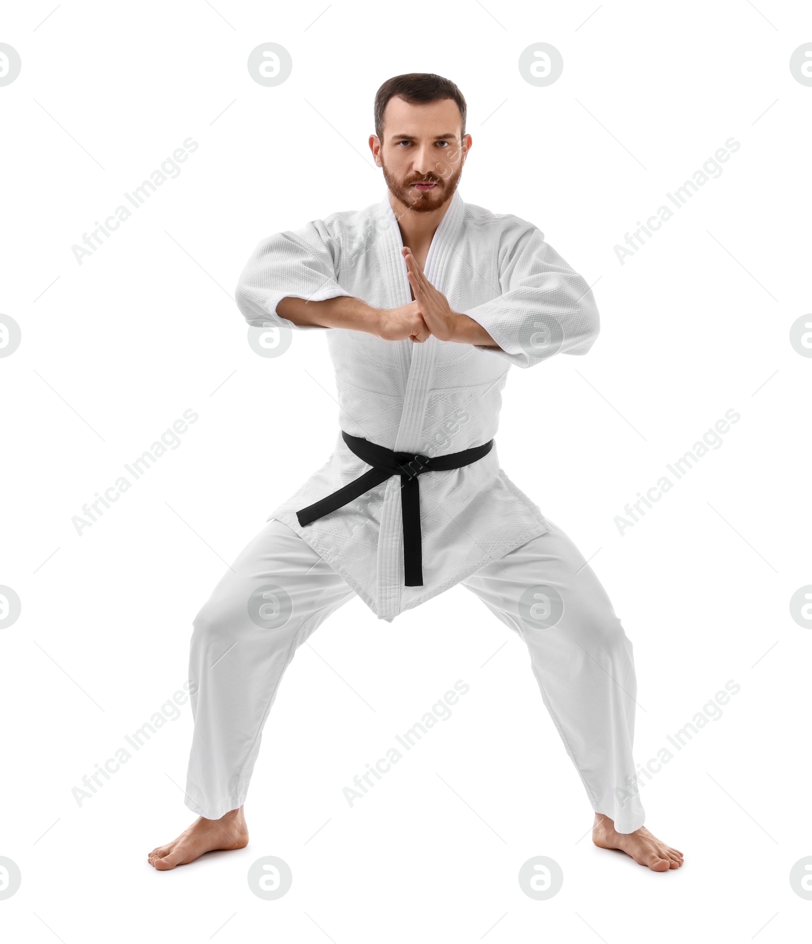 Photo of Man in uniform practicing karate on white background