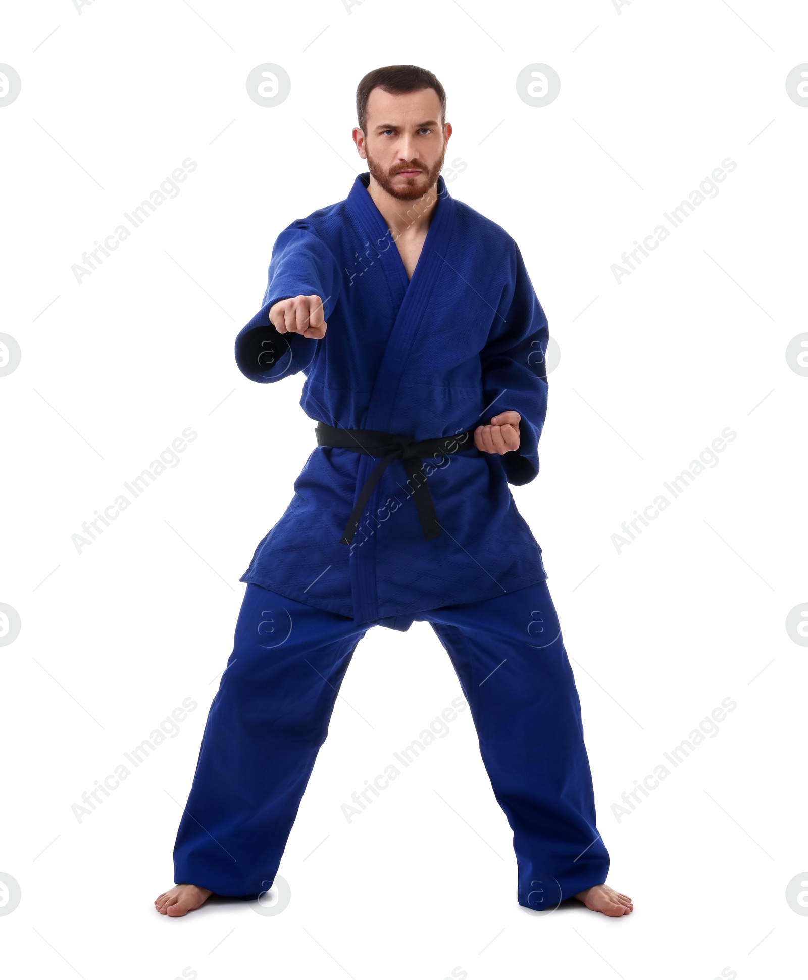 Photo of Man in uniform practicing karate on white background