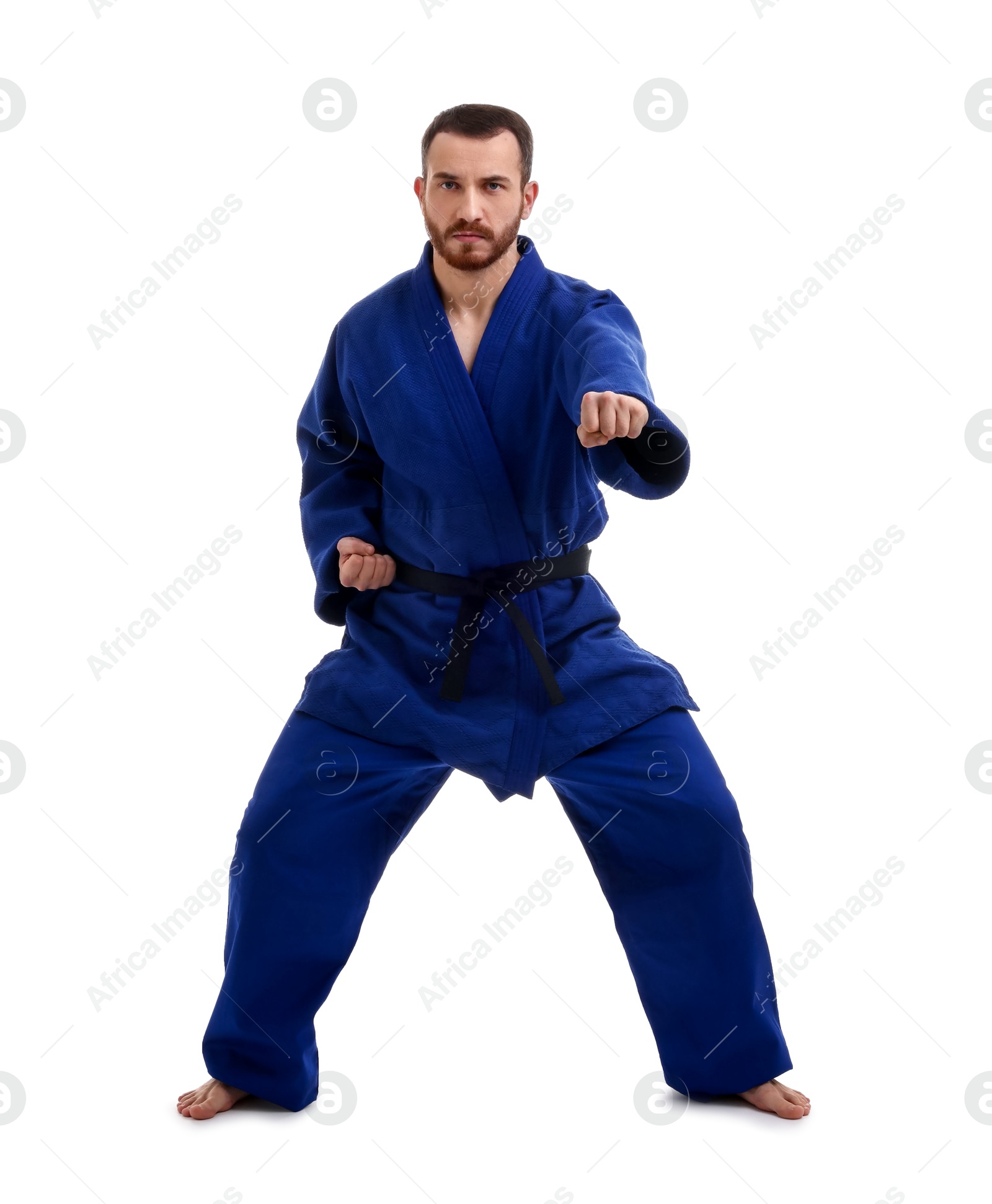 Photo of Man in uniform practicing karate on white background