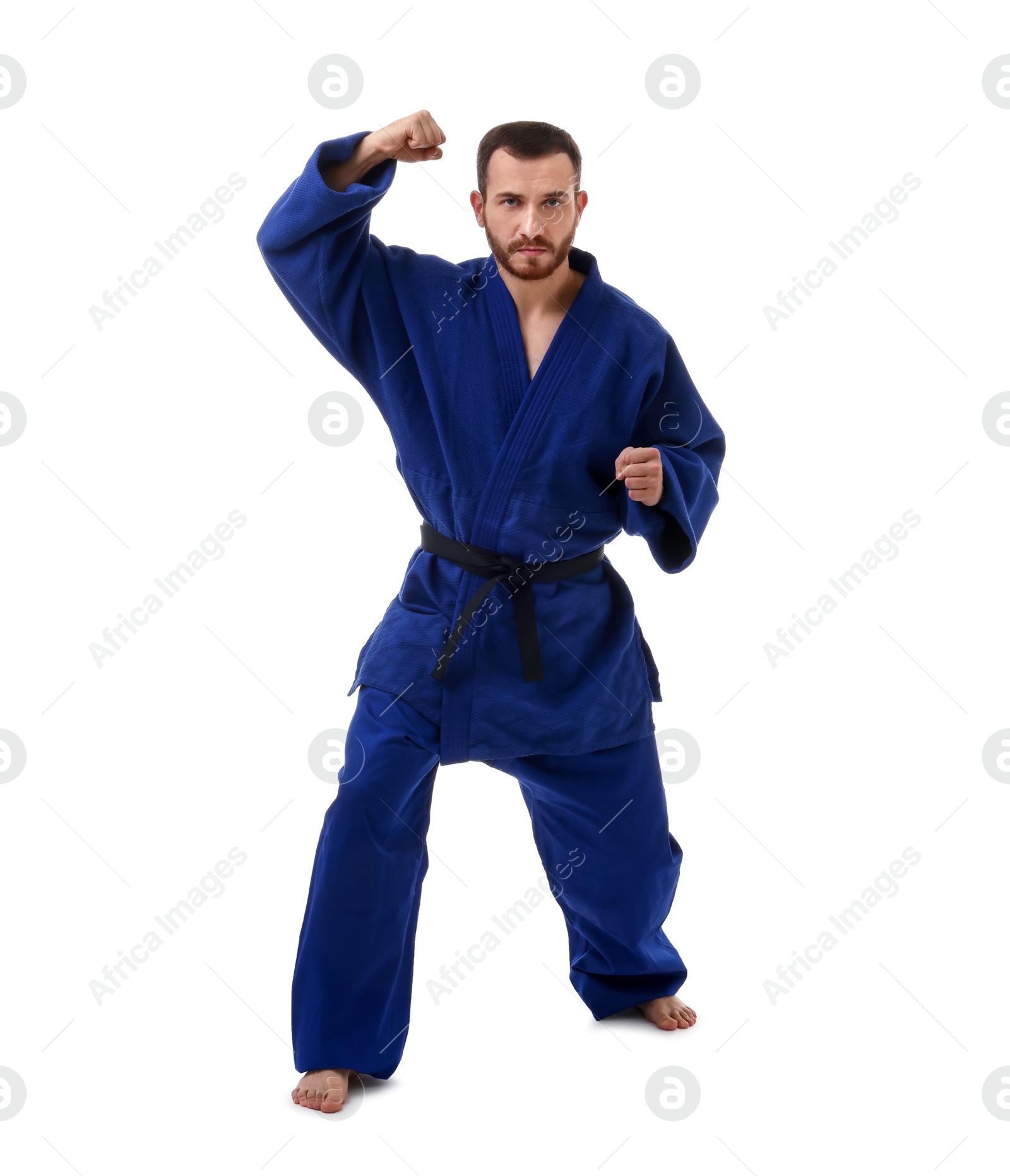 Photo of Man in uniform practicing karate on white background