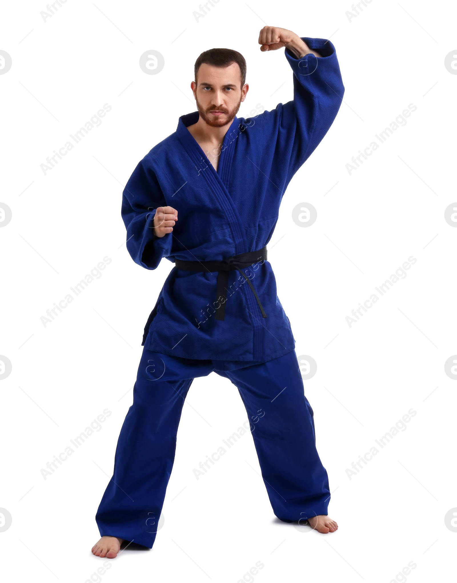 Photo of Man in uniform practicing karate on white background