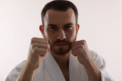 Photo of Karate fighter in uniform on white background