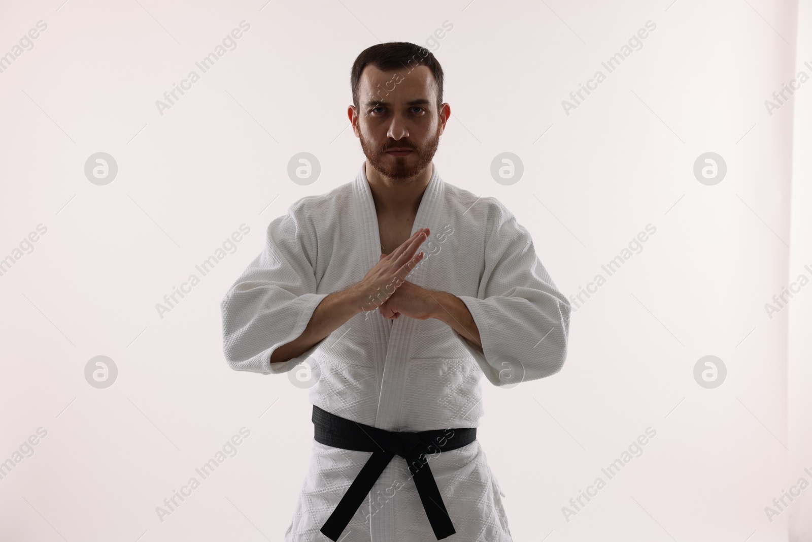 Photo of Karate fighter in uniform on white background