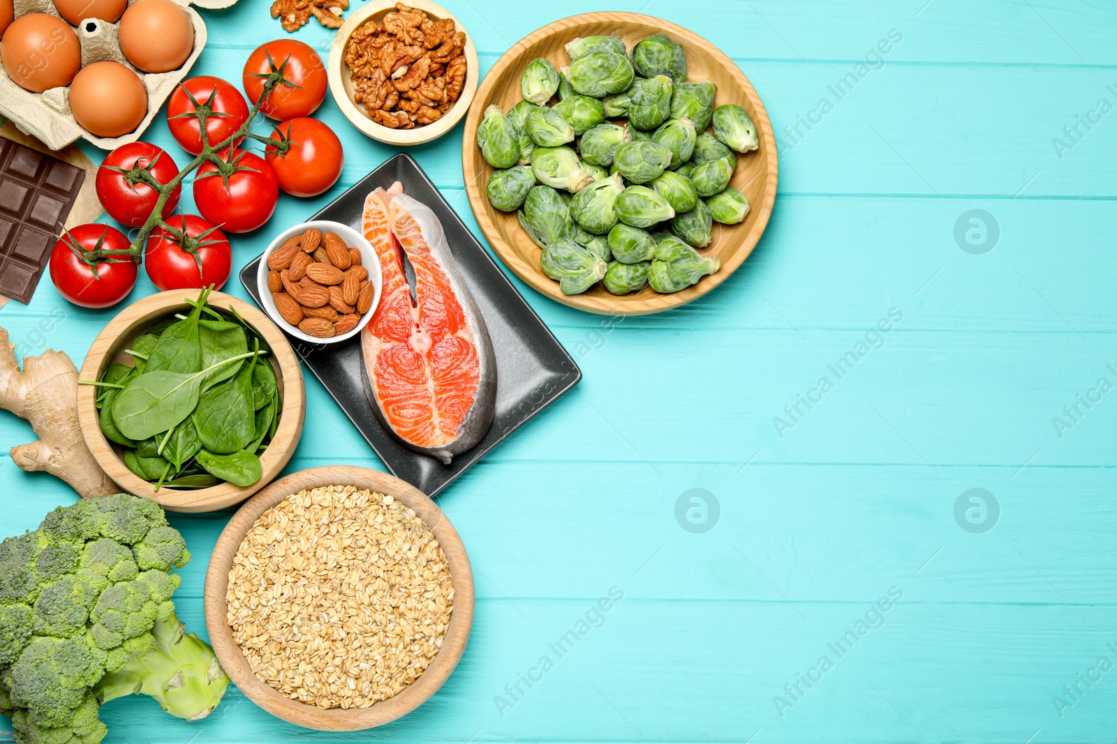 Photo of Different fresh products rich in melatonin on light blue wooden table, flat lay. Space for text