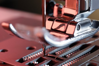 Photo of Macro view of sewing machine with thread