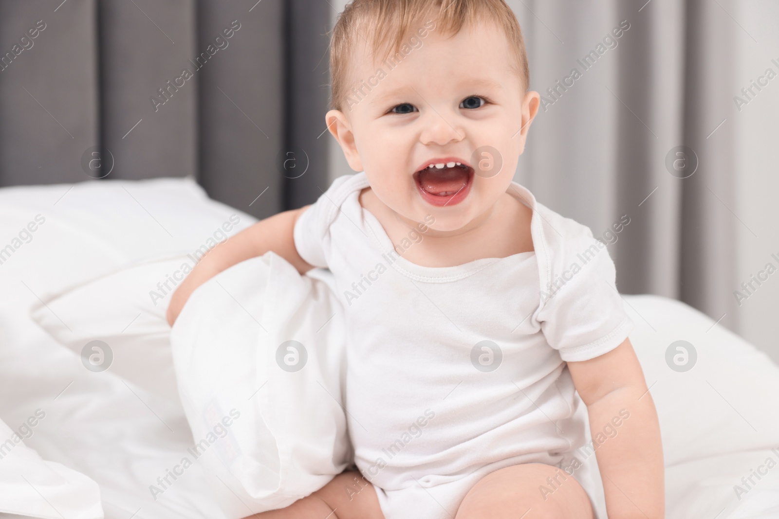 Photo of Cute little baby on bed at home