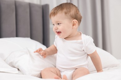 Photo of Cute little baby on bed at home