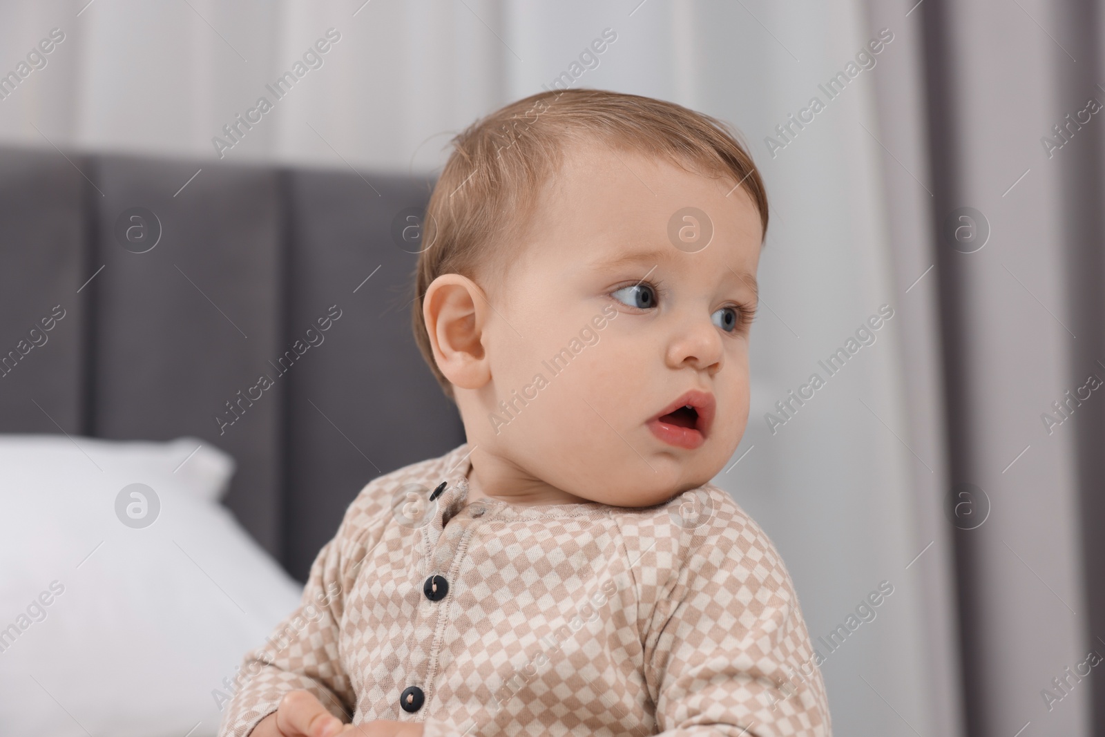 Photo of Cute little baby on bed at home