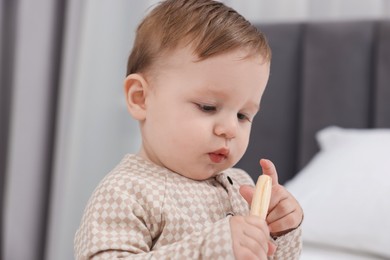 Photo of Adorable little baby with toy at home