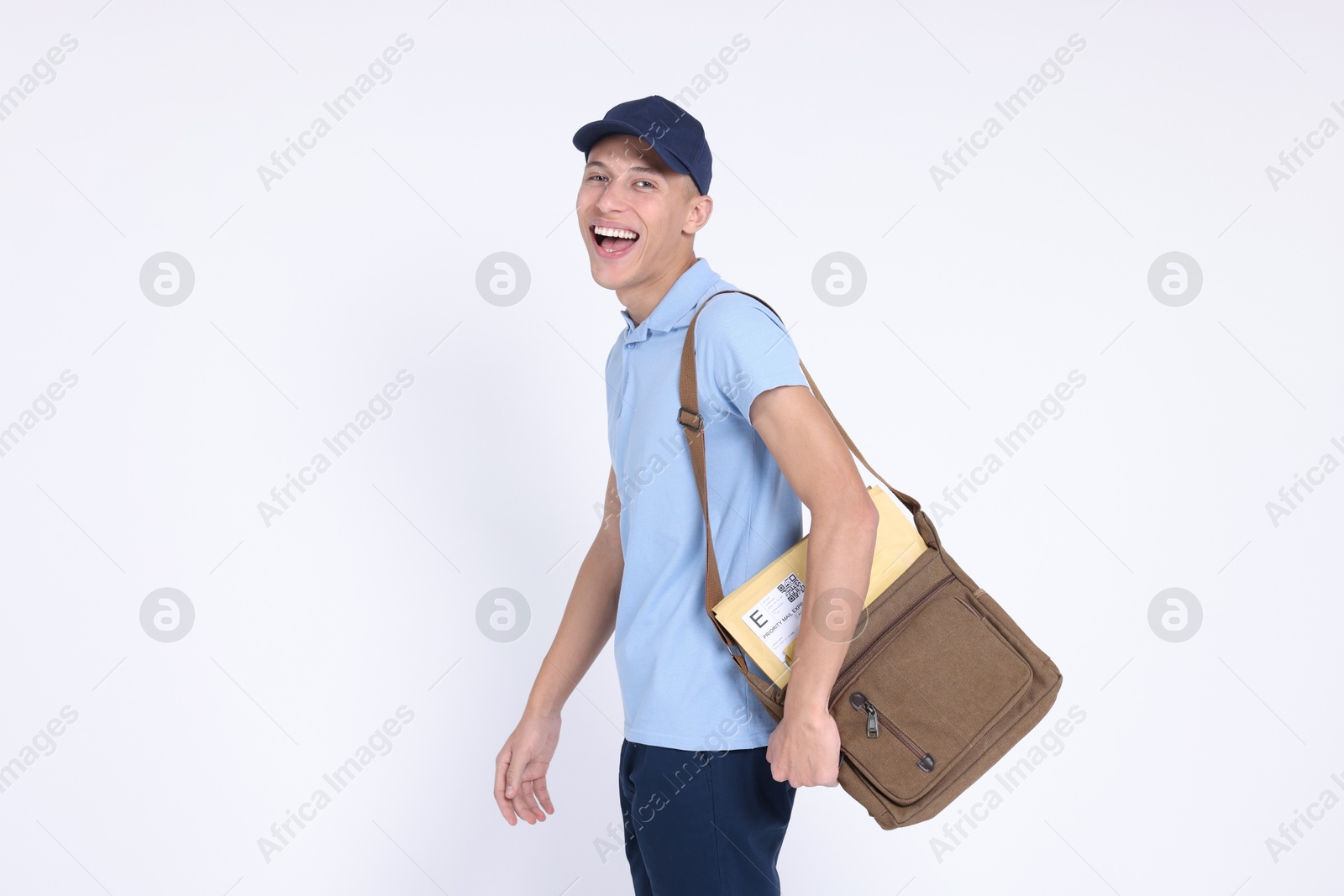 Photo of Happy postman with bag and envelopes on white background