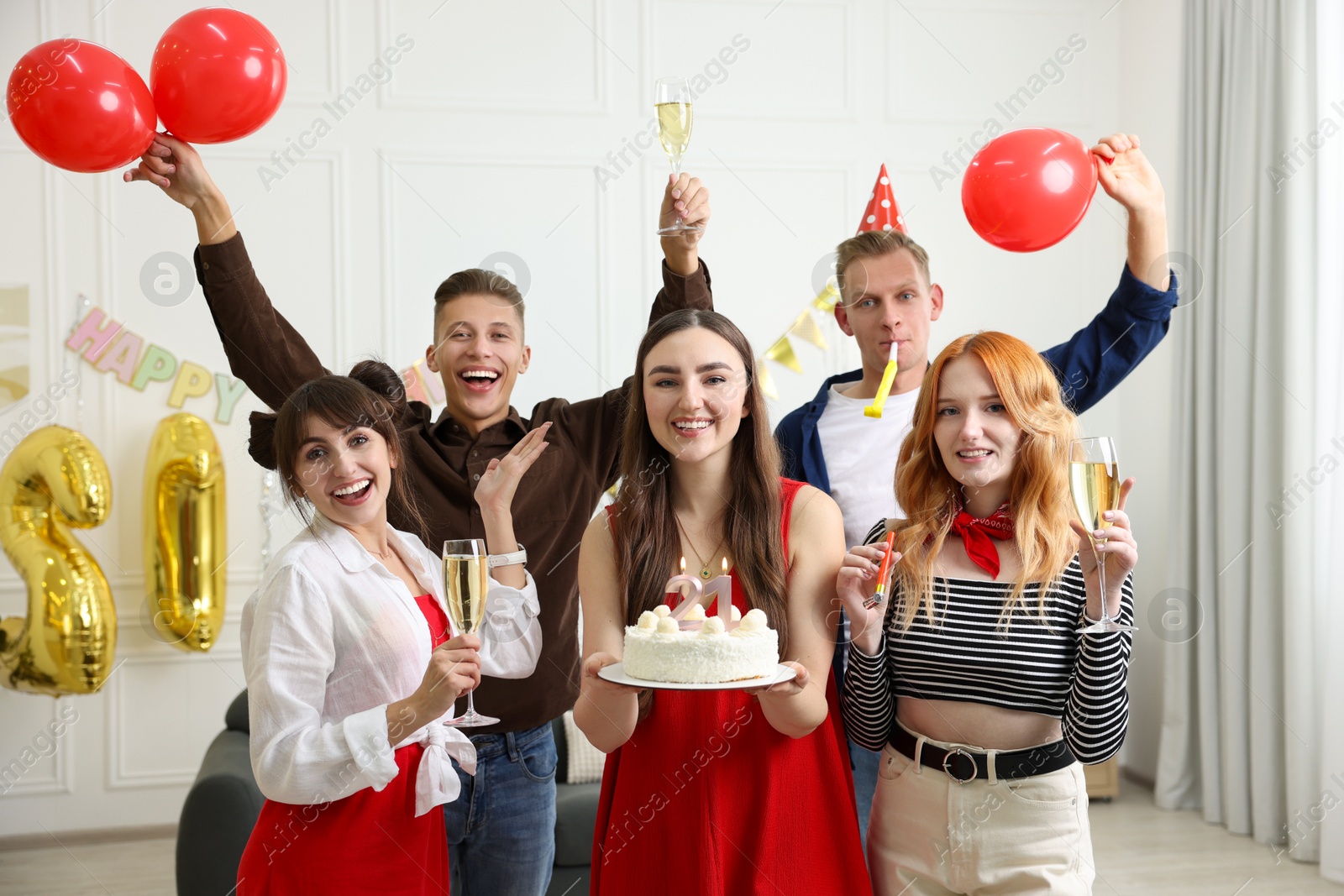 Photo of 21st birthday. Group of happy friends with tasty cake having coming of age party at home