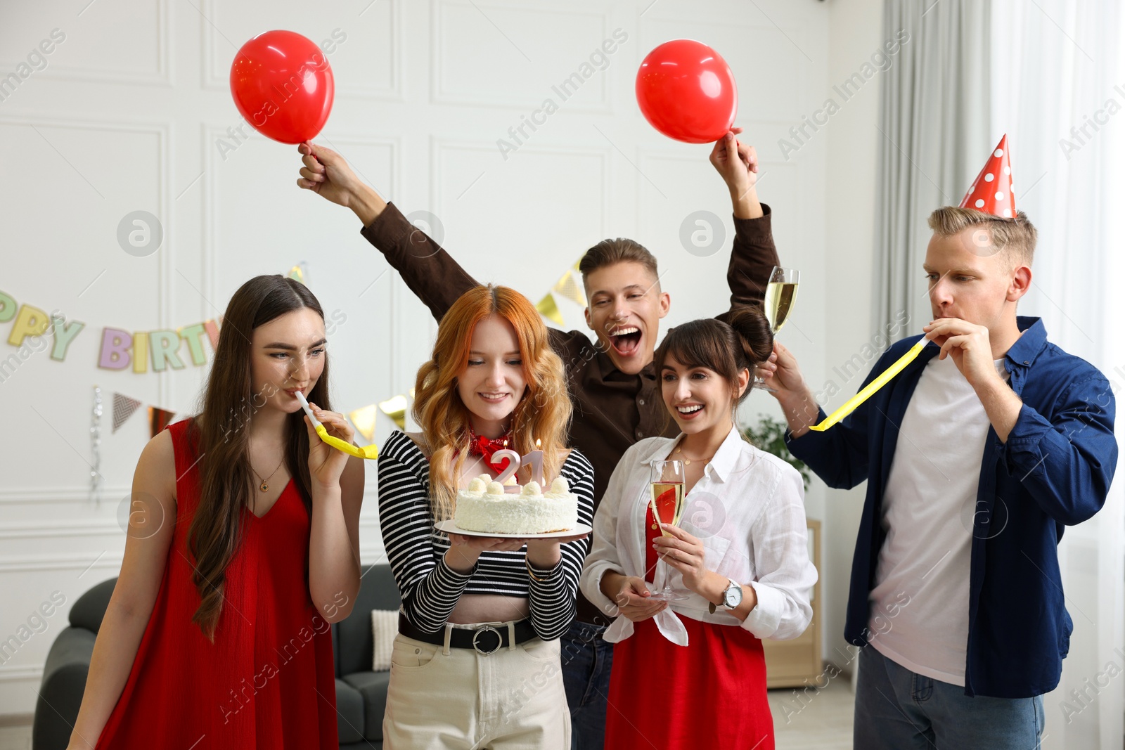 Photo of 21st birthday. Group of happy friends with tasty cake having coming of age party at home