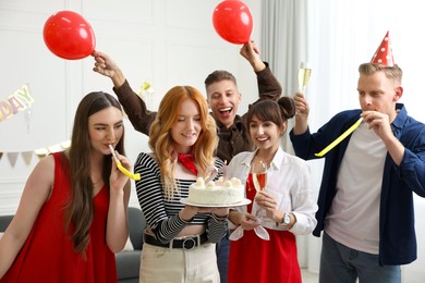 Photo of 21st birthday. Group of happy friends with tasty cake having coming of age party at home