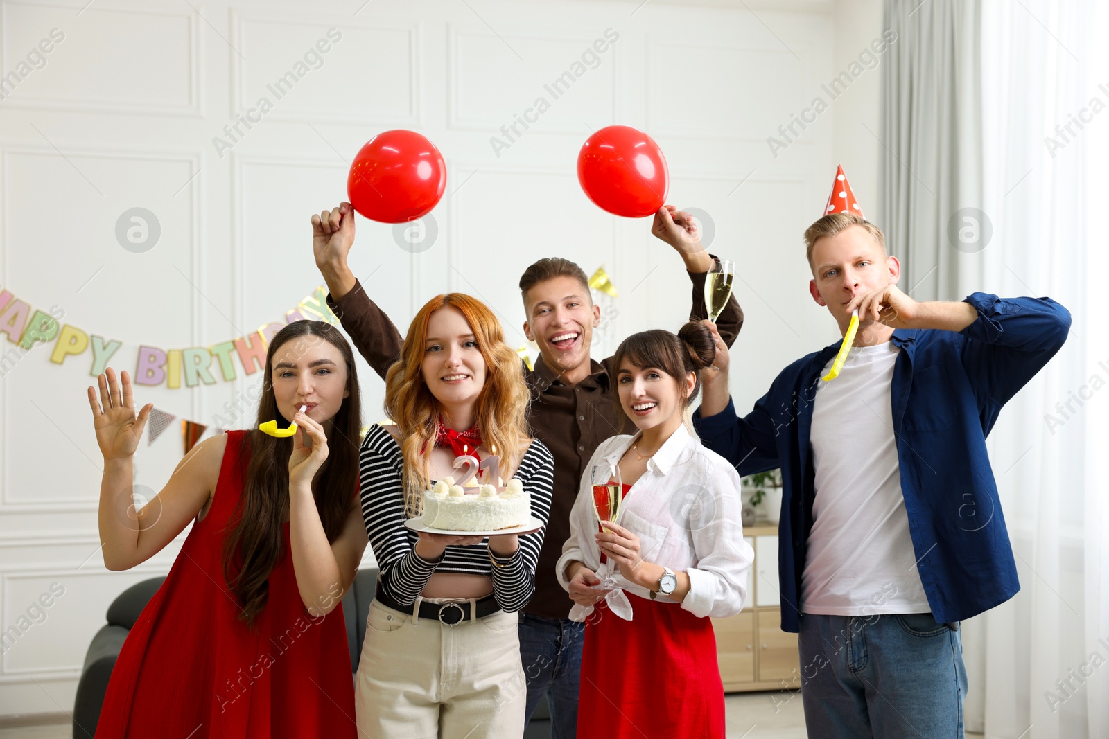 Photo of 21st birthday. Group of happy friends with tasty cake having coming of age party at home