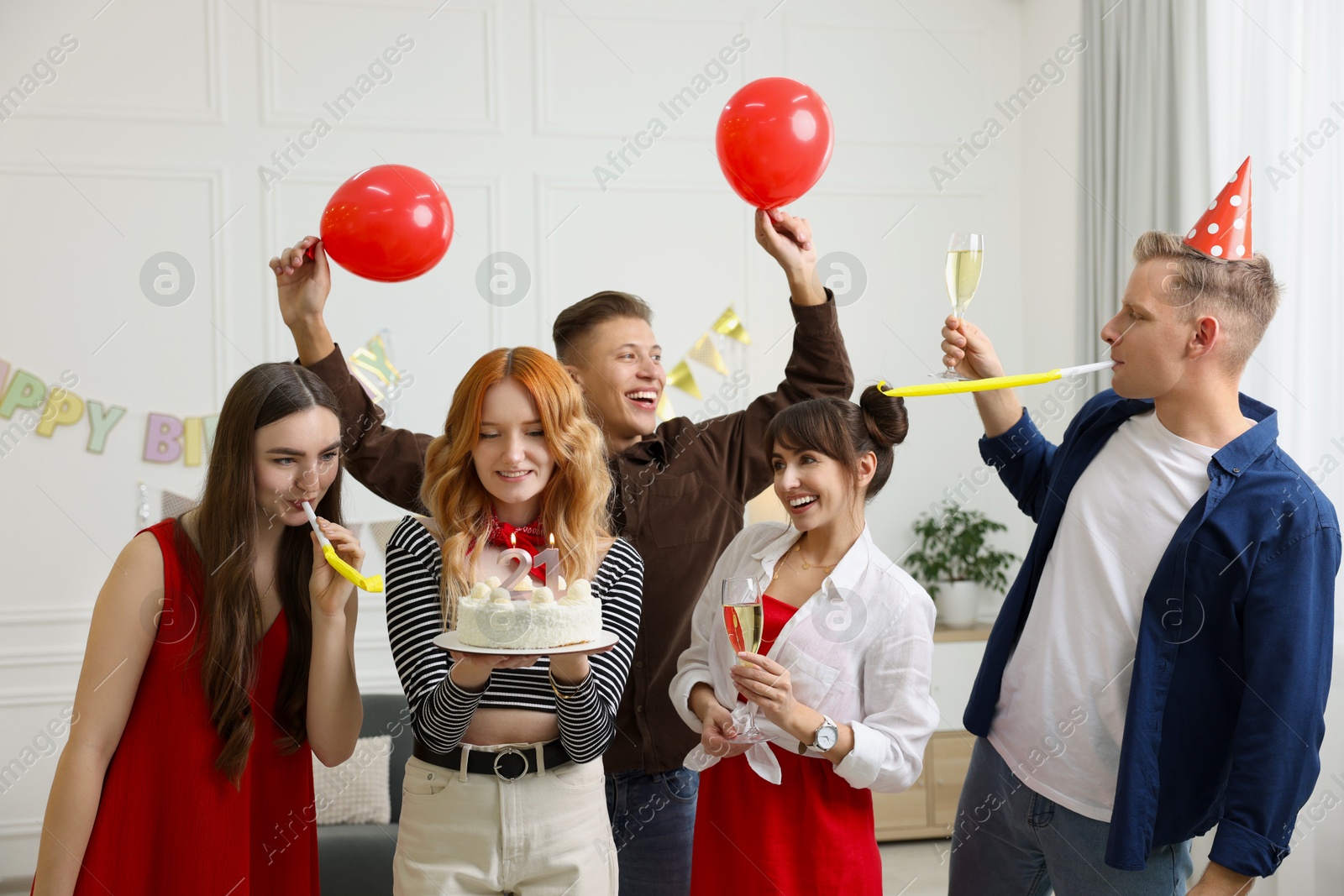 Photo of 21st birthday. Group of happy friends with tasty cake having coming of age party at home