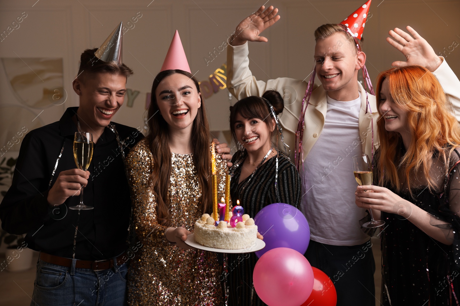 Photo of 18th birthday. Group of friends with tasty cake having coming of age party at home