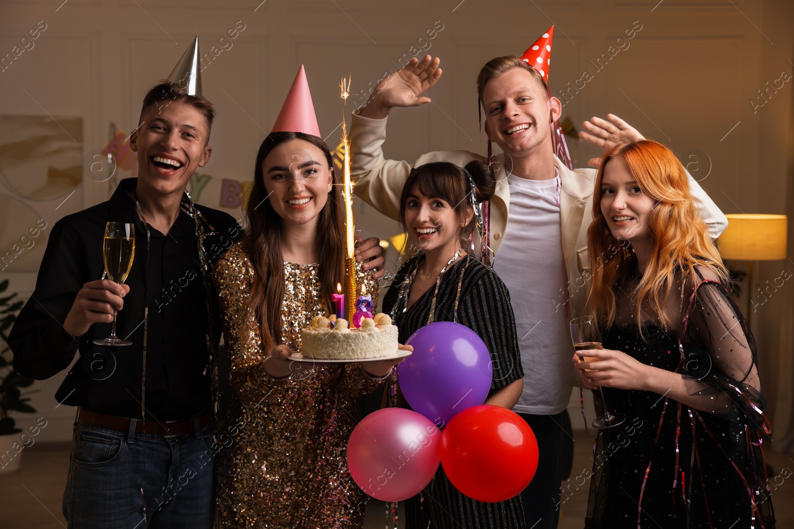 Photo of 18th birthday. Group of friends with tasty cake having coming of age party at home