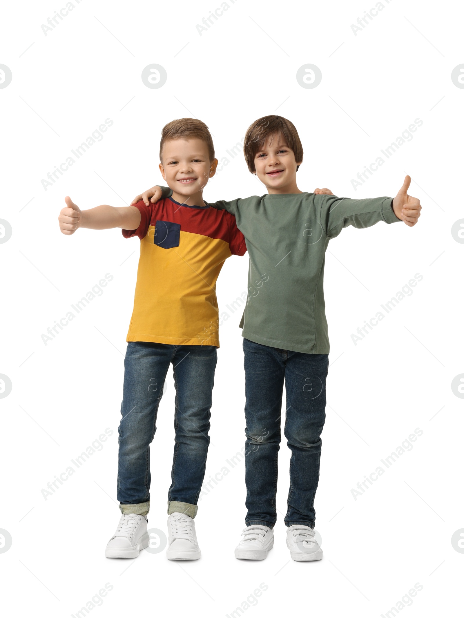 Photo of Cute brothers showing thumbs up on white background