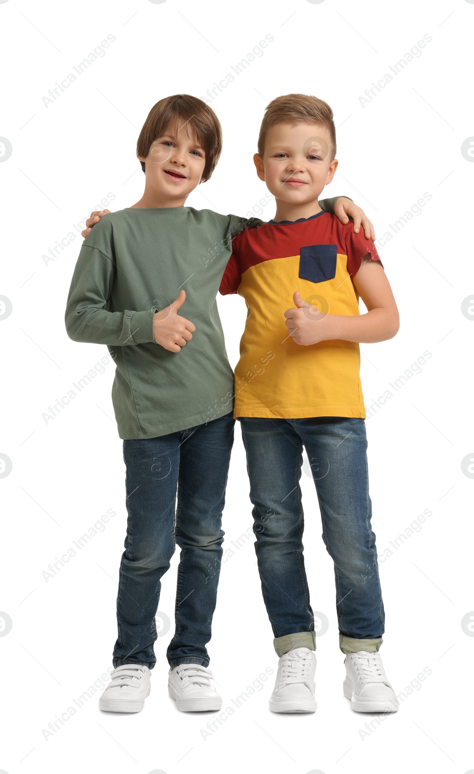 Photo of Cute brothers showing thumbs up on white background